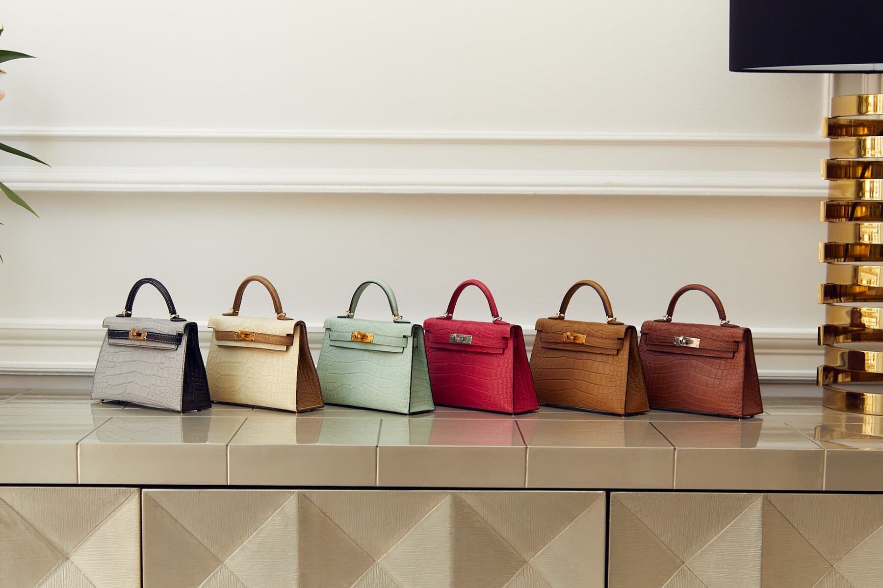 A line of Hermès Kelly bags in varied leathers and colours